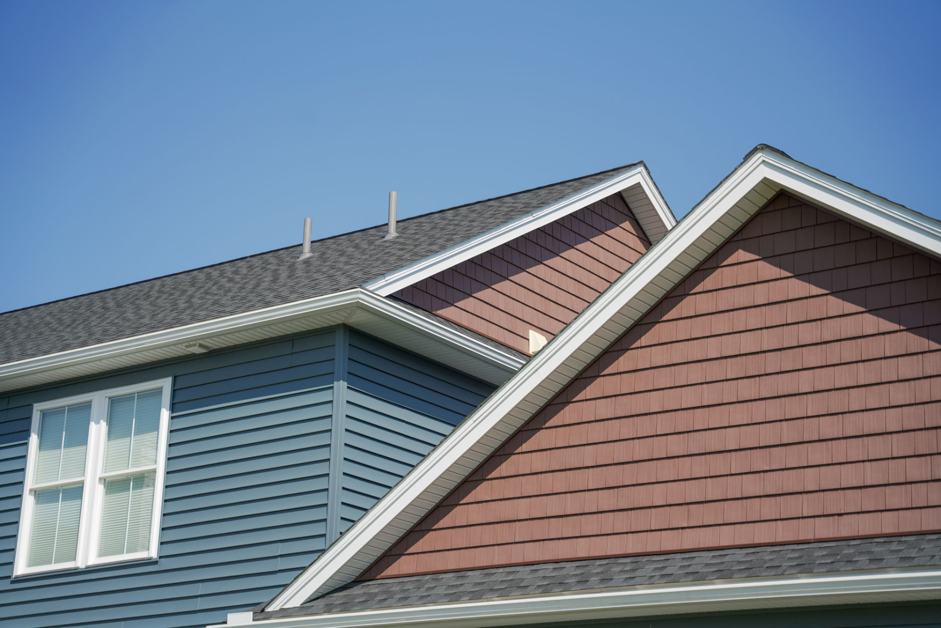Yoder Residence — rooflines with blue lap siding, cedar-look shake gables, and crisp white trim — KB Builders, Central Pennsylvania