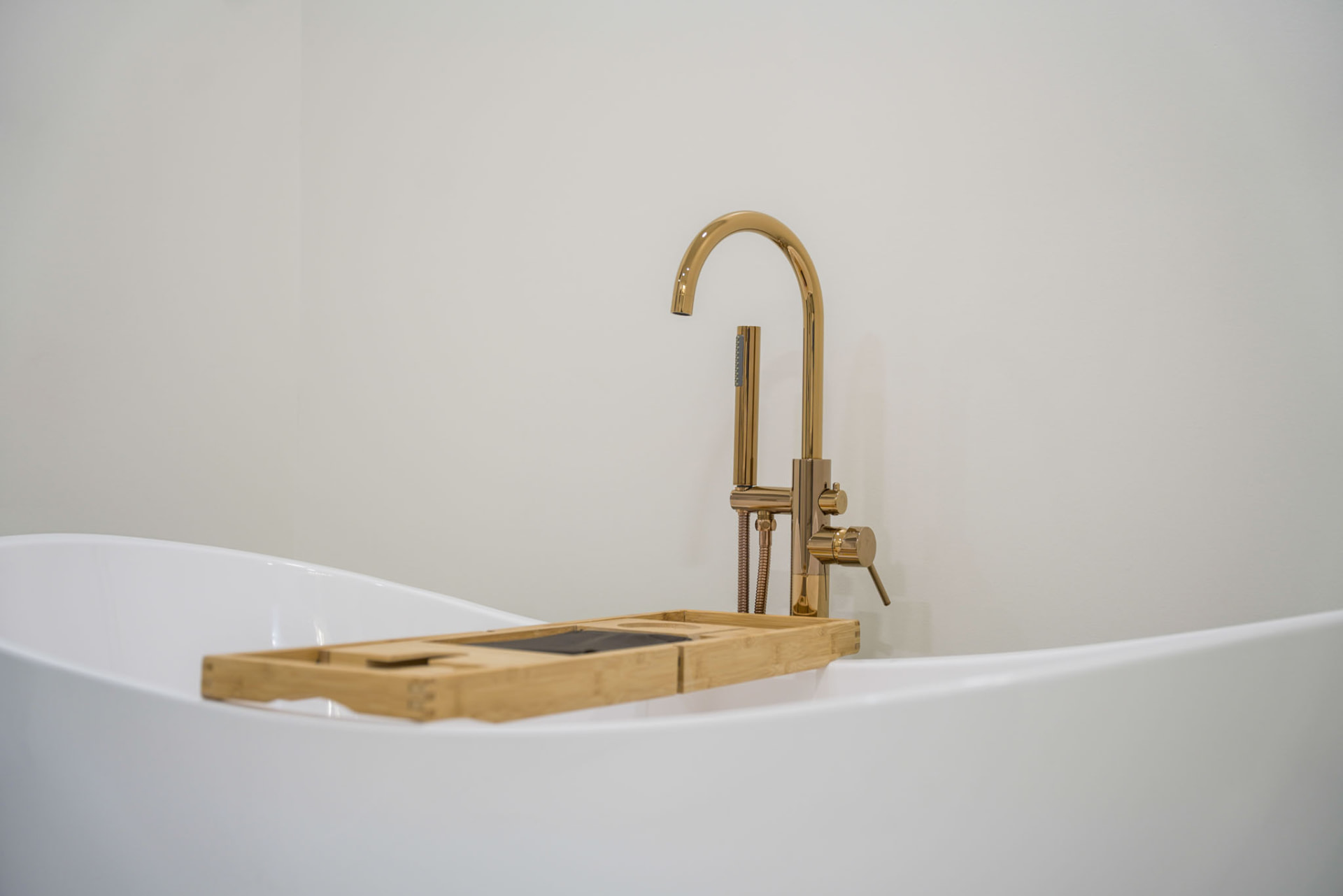 Yoder Residence — brushed gold floor-mounted tub filler detail at the soaking tub — KB Builders, Central Pennsylvania