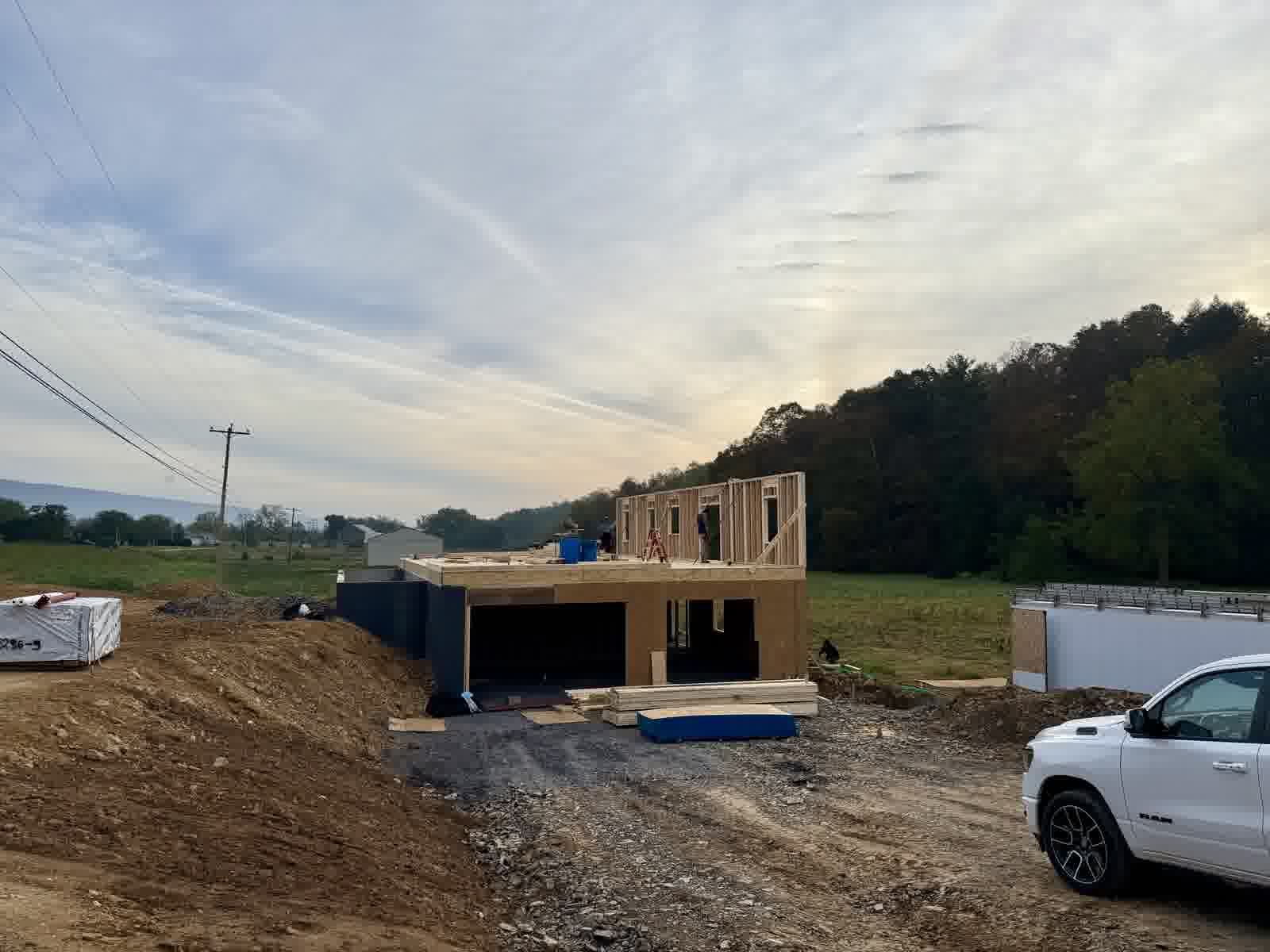 Custom home under construction with second-story wall framing and sheathing in a Central Pennsylvania valley — KB Builders