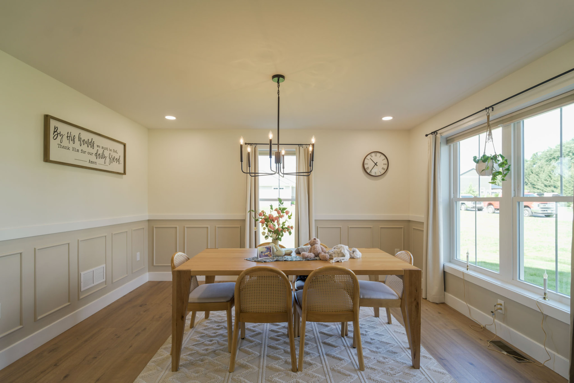 Yoder Residence — formal dining room with paneled wainscoting, black chandelier, and wide-plank oak flooring — KB Builders, Central Pennsylvania