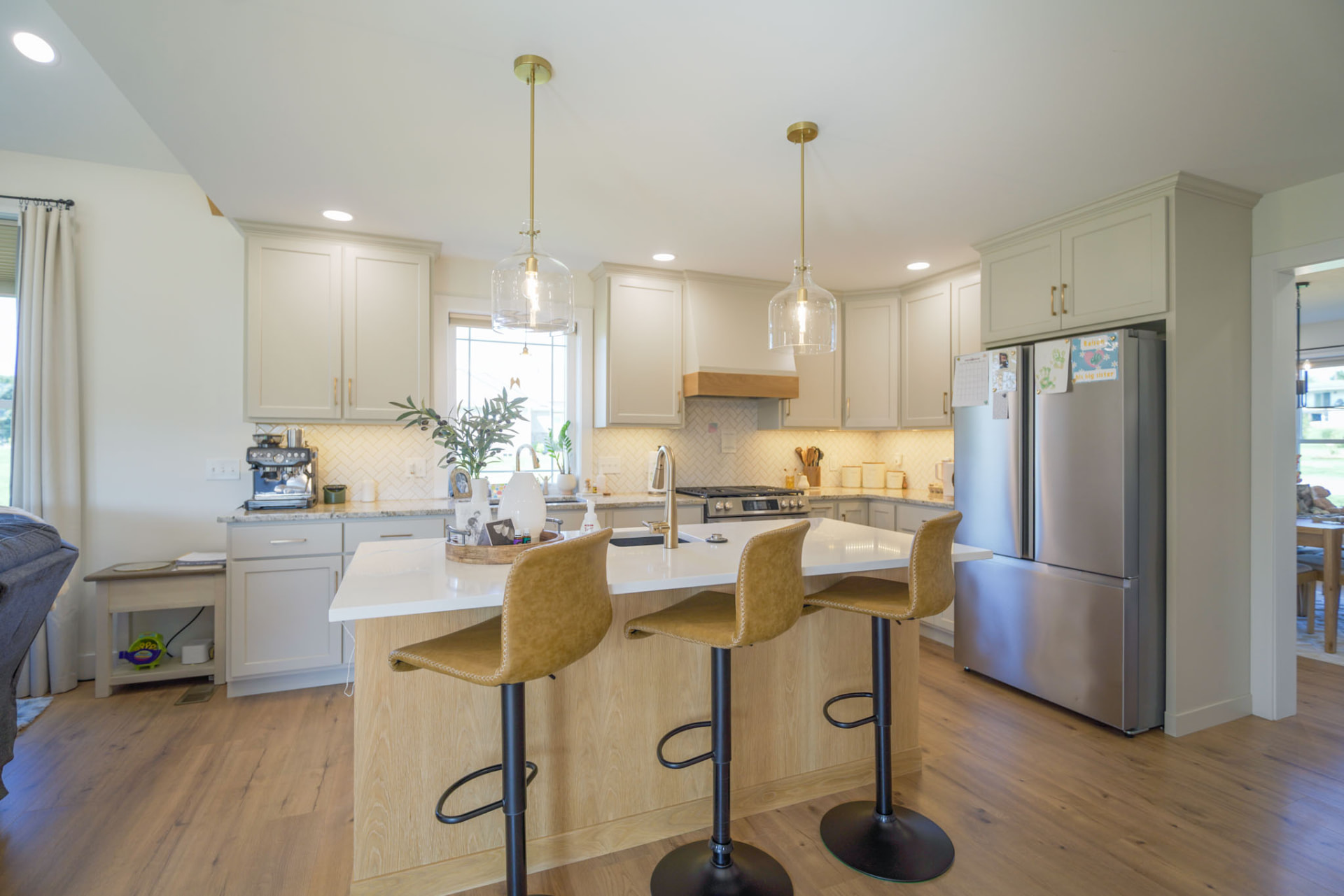 Yoder Residence — kitchen with quartz-topped white oak island, brass pendants, and sage cabinetry — KB Builders, Central Pennsylvania
