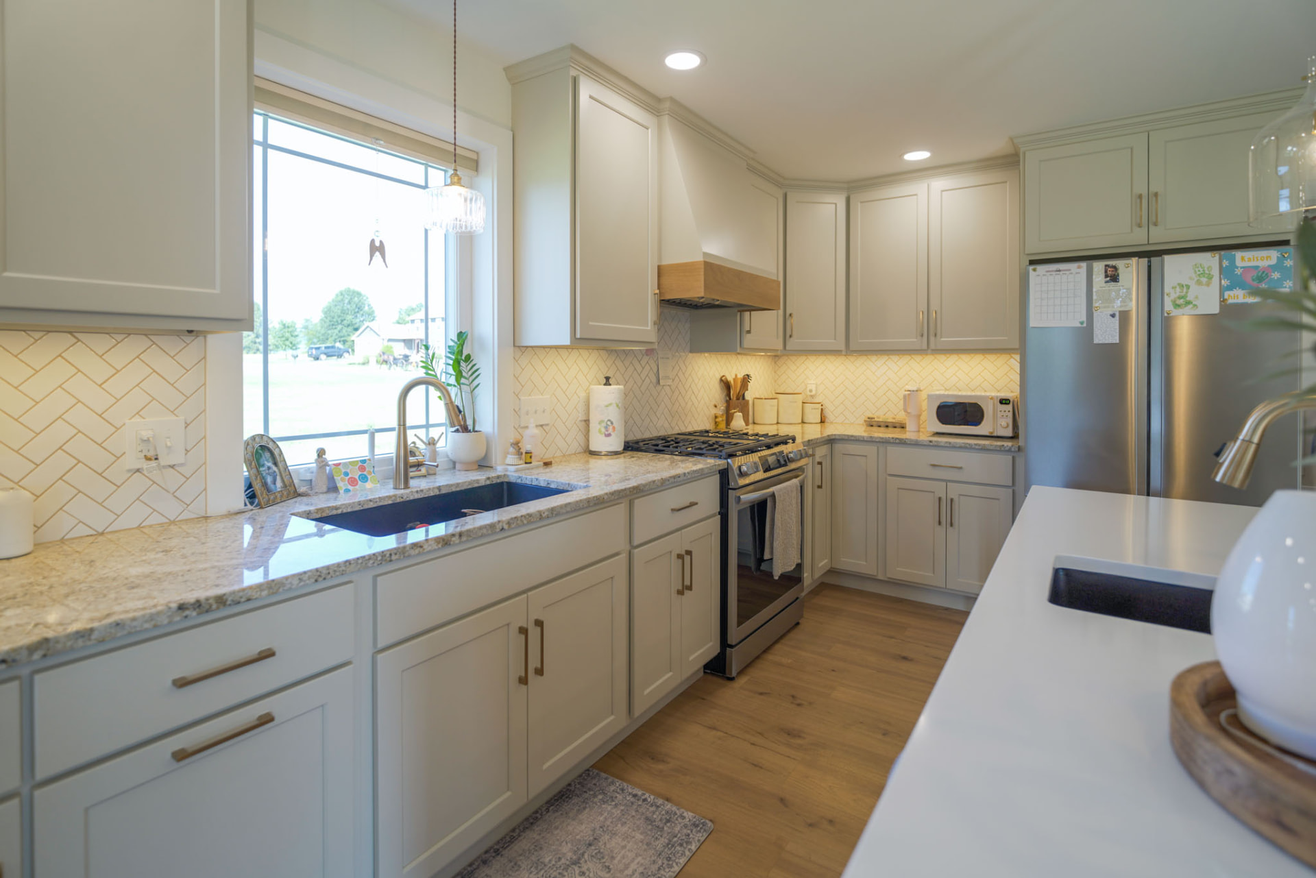Yoder Residence — kitchen with herringbone tile backsplash, granite counters, and gas range — KB Builders, Central Pennsylvania