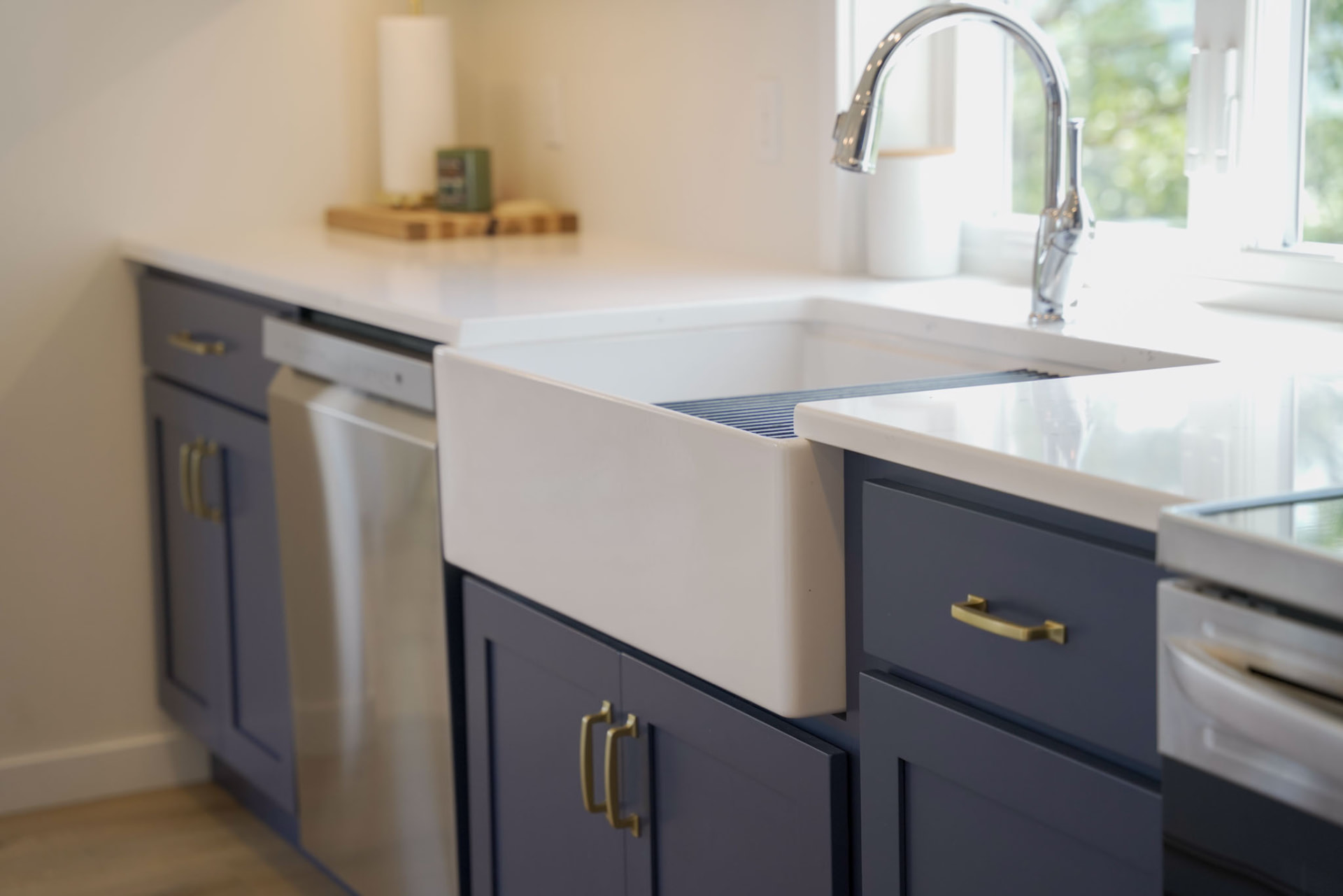 Byler Residence — farmhouse apron-front sink with gooseneck faucet and navy cabinetry — KB Builders, Central Pennsylvania