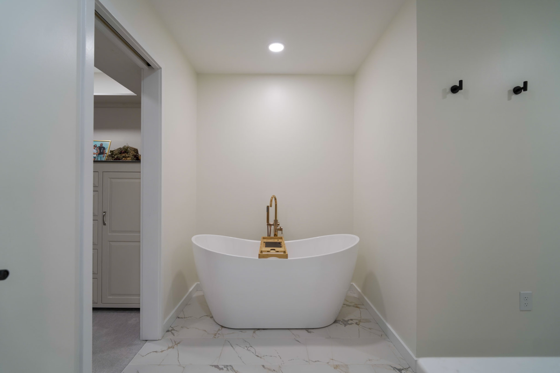 Yoder Residence — freestanding soaking tub in a tiled alcove off the primary bath — KB Builders, Central Pennsylvania