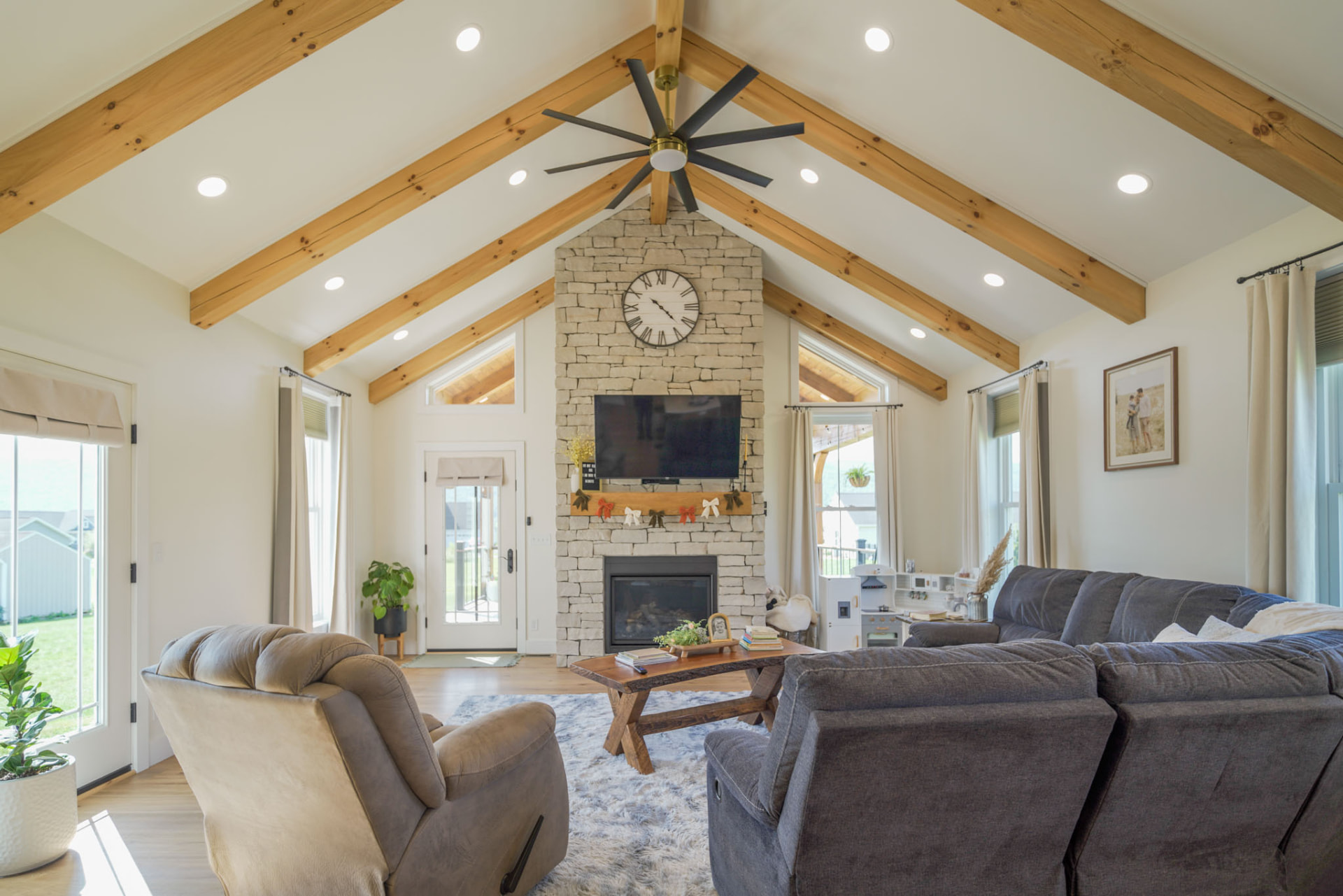 Yoder Residence — great room with cathedral ceiling, exposed timber beams, and floor-to-ceiling stone fireplace — KB Builders, Central Pennsylvania