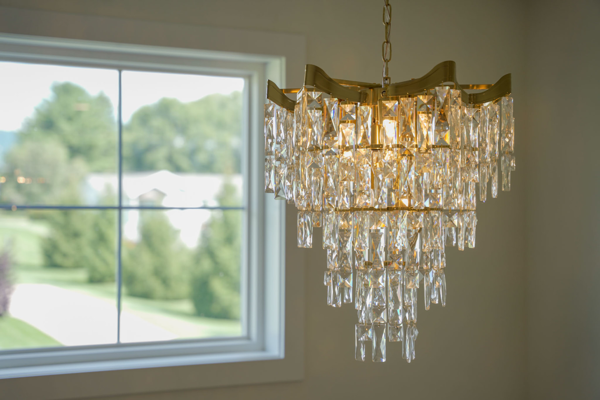 Yoder Residence — crystal tiered chandelier beside a window overlooking the lawn — KB Builders, Central Pennsylvania