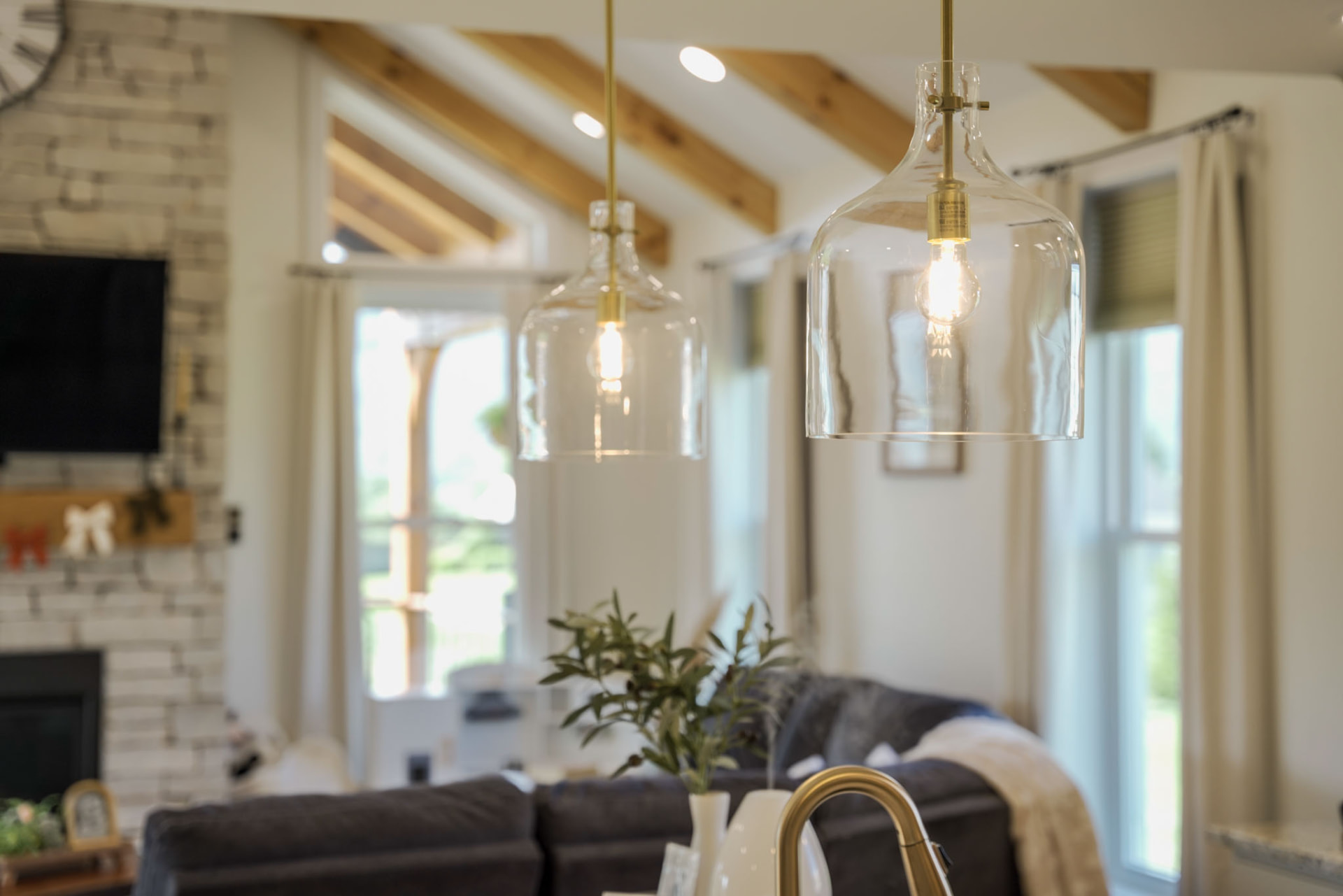 Yoder Residence — clear glass and brass pendant light detail above the kitchen island — KB Builders, Central Pennsylvania
