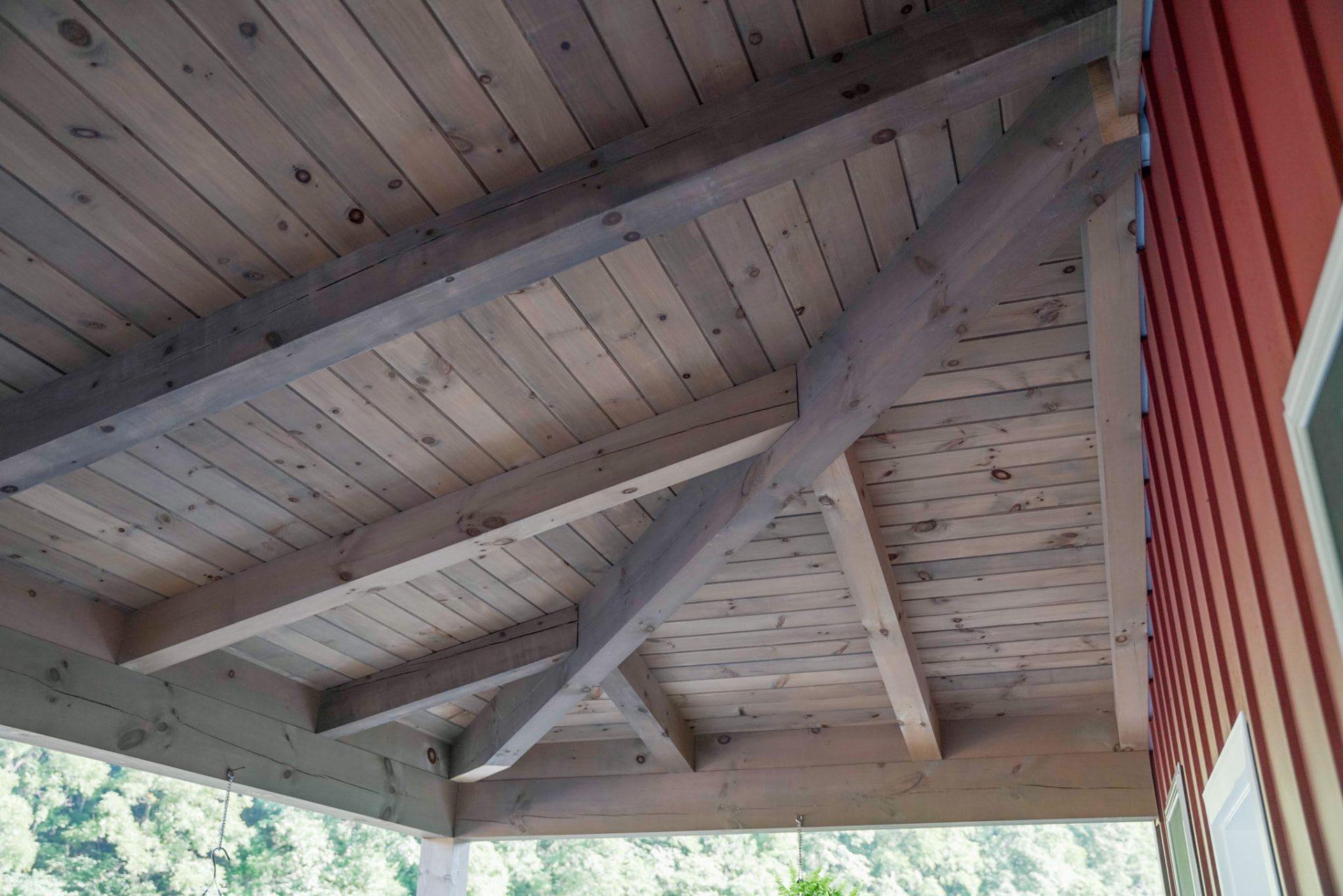 Peachy Residence — timber truss and tongue-and-groove pine porch ceiling detail — KB Builders, McVeytown, PA