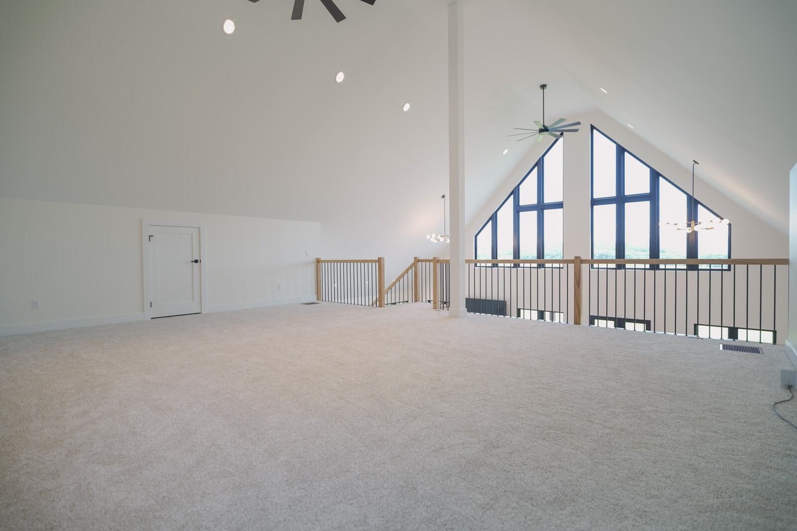 Upstairs loft with cathedral ceiling and prow-front gable windows overlooking the valley — custom home by KB Builders, Mifflintown, PA