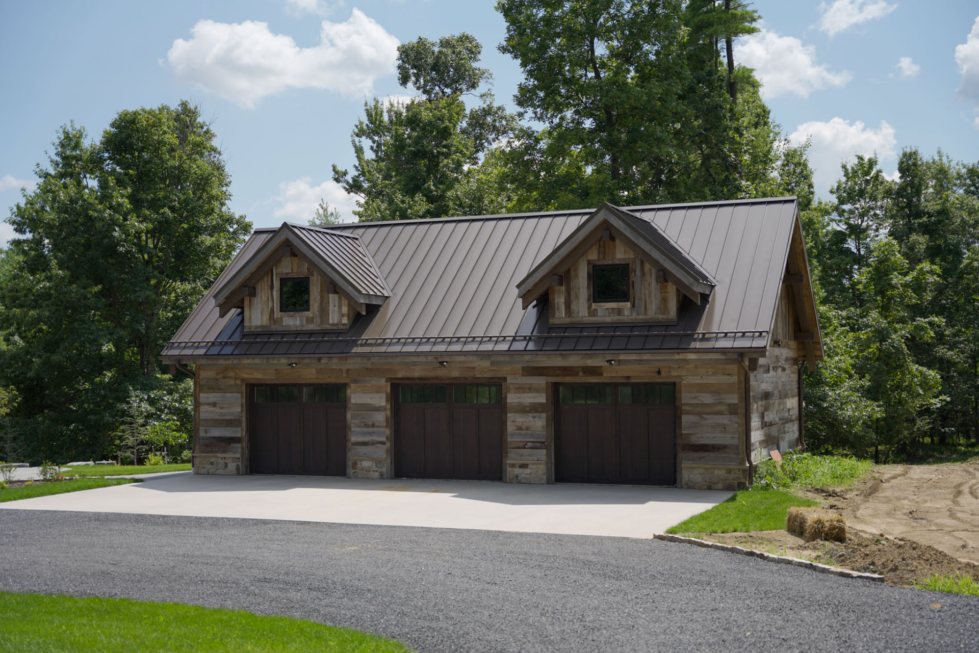 Wright Residence — detached three-car carriage garage with matching barnwood siding, dormers, and metal roof — KB Builders, Central Pennsylvania