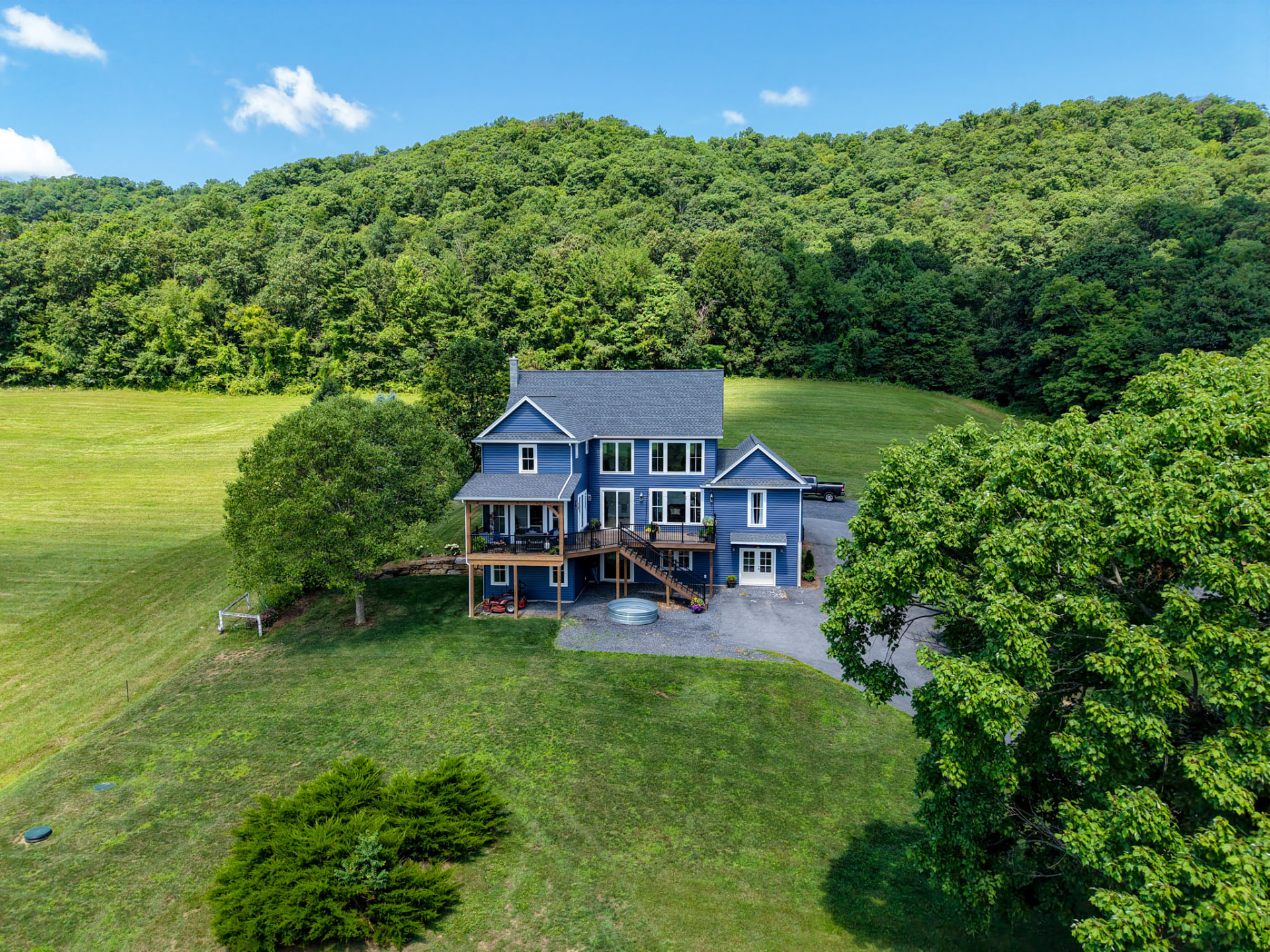 Byler Residence — aerial view of the rear deck and walk-out lower level backed by forested hillside — KB Builders, Central Pennsylvania