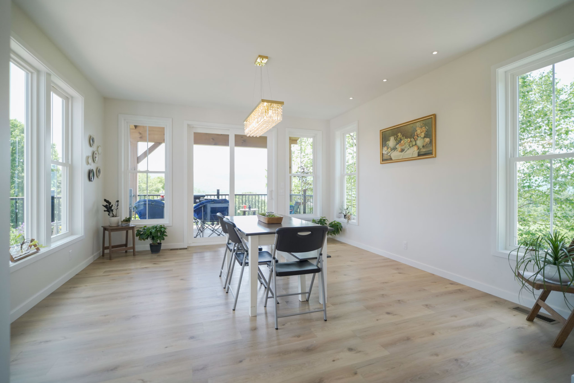 Byler Residence — dining area with linear crystal chandelier and deck access — KB Builders, Central Pennsylvania