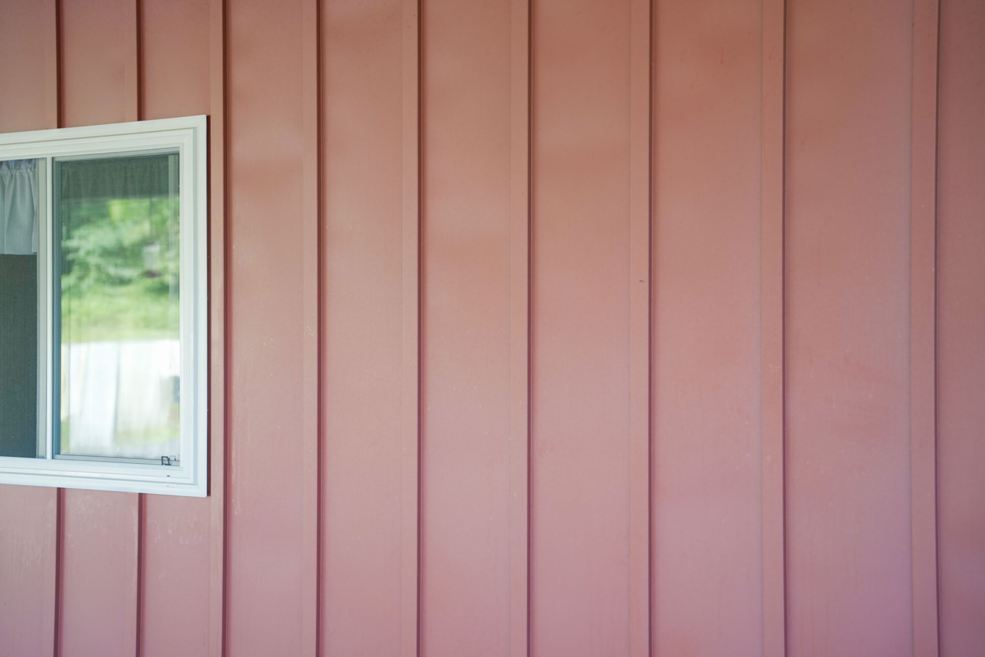 Peachy Residence — close-up of barn-red board-and-batten siding with a white-trimmed window — KB Builders, McVeytown, PA