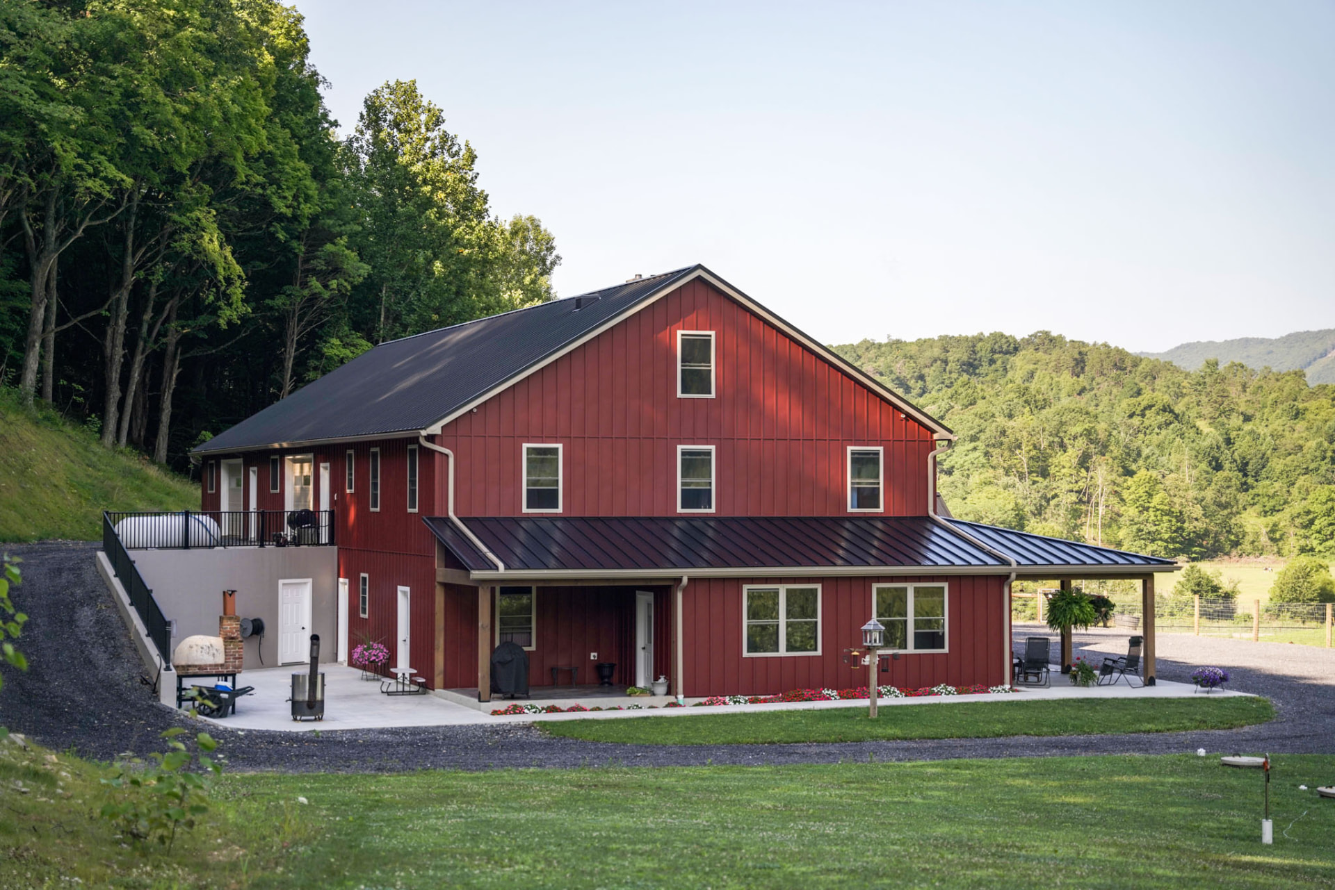 Peachy Residence — rear elevation of a barndominium with gable end, patio, and standing-seam metal roof — KB Builders, McVeytown, PA