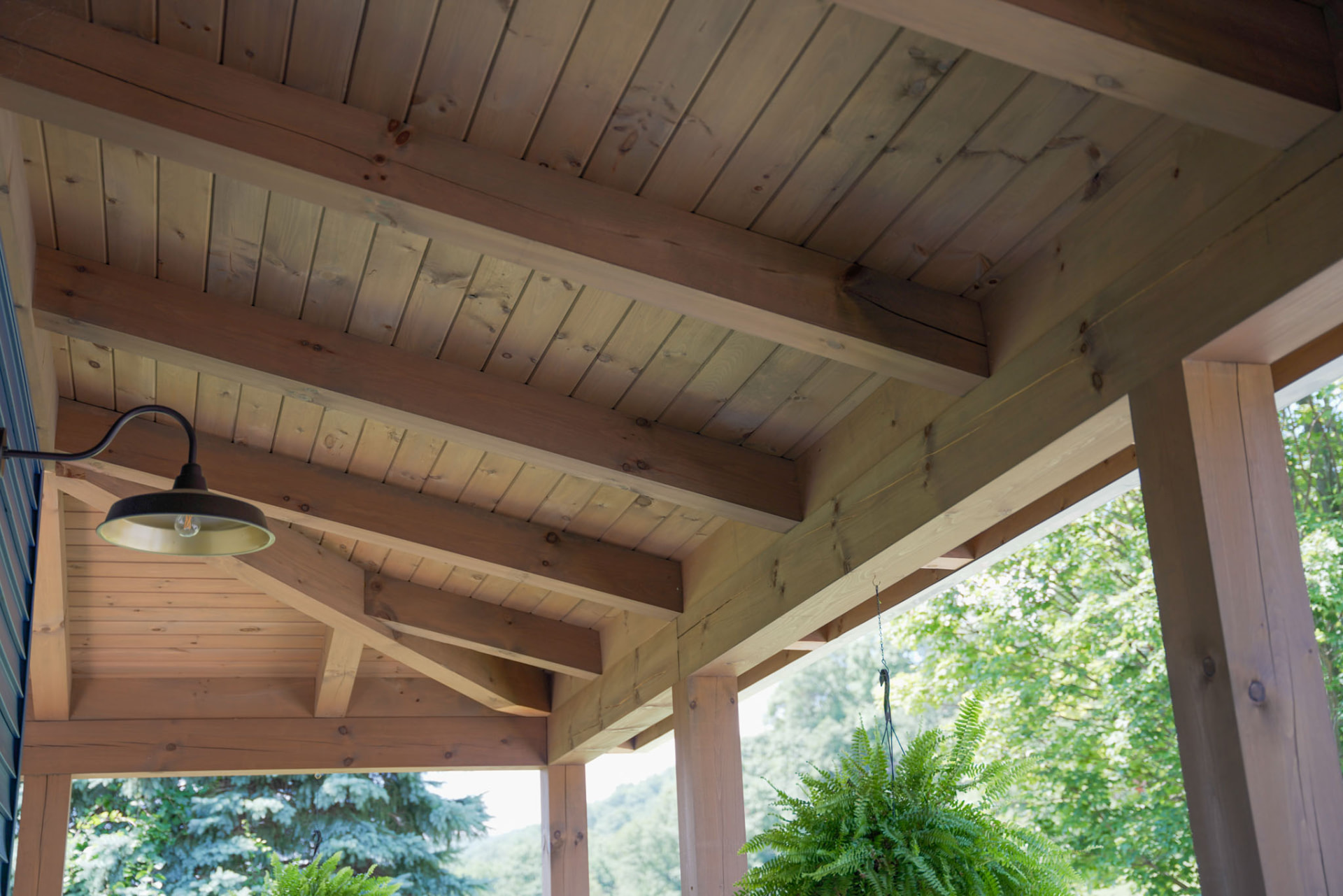 Byler Residence — covered porch with exposed timber rafters, tongue-and-groove ceiling, and barn light — KB Builders, Central Pennsylvania
