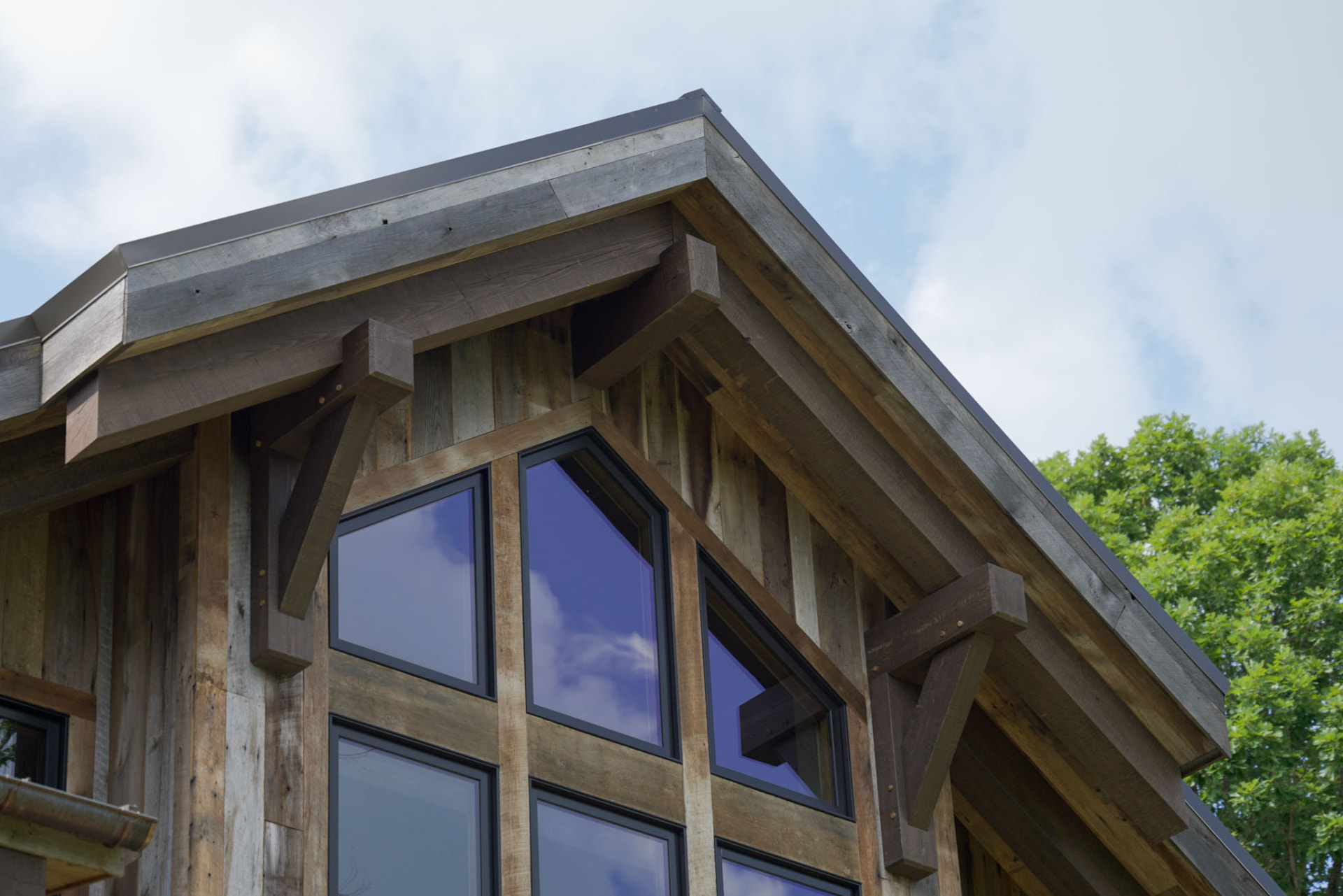 Wright Residence — timber gable detail with reclaimed wood siding and black-framed windows — KB Builders, Central Pennsylvania
