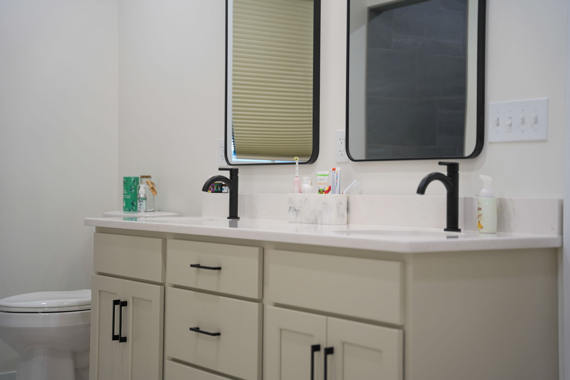 Yoder Residence — quartz-topped double vanity with black faucets and framed mirrors — KB Builders, Central Pennsylvania