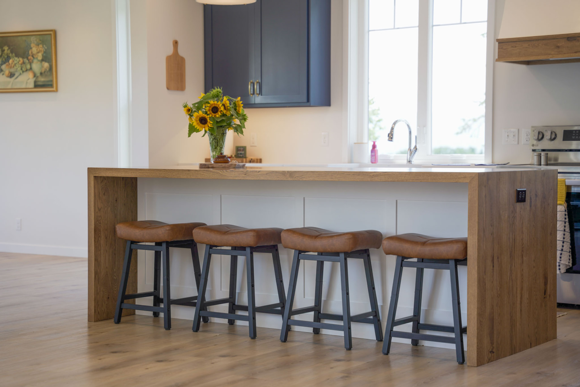 Custom kitchen with white oak waterfall island and navy cabinetry remodeled by KB Builders, Central Pennsylvania