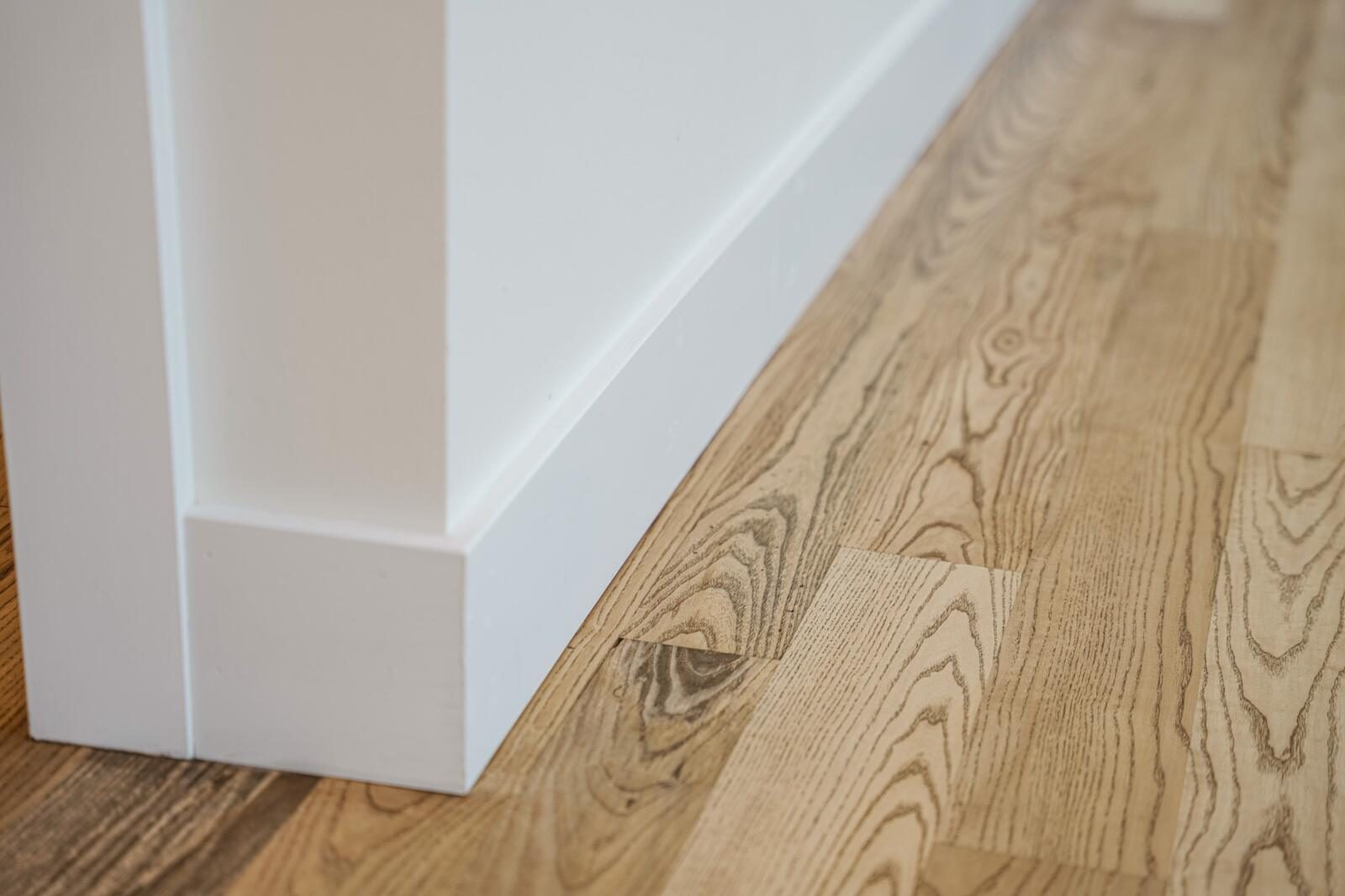 Detail of custom trim and hand-finished hardwood flooring in a KB Builders custom home, Mifflintown, PA