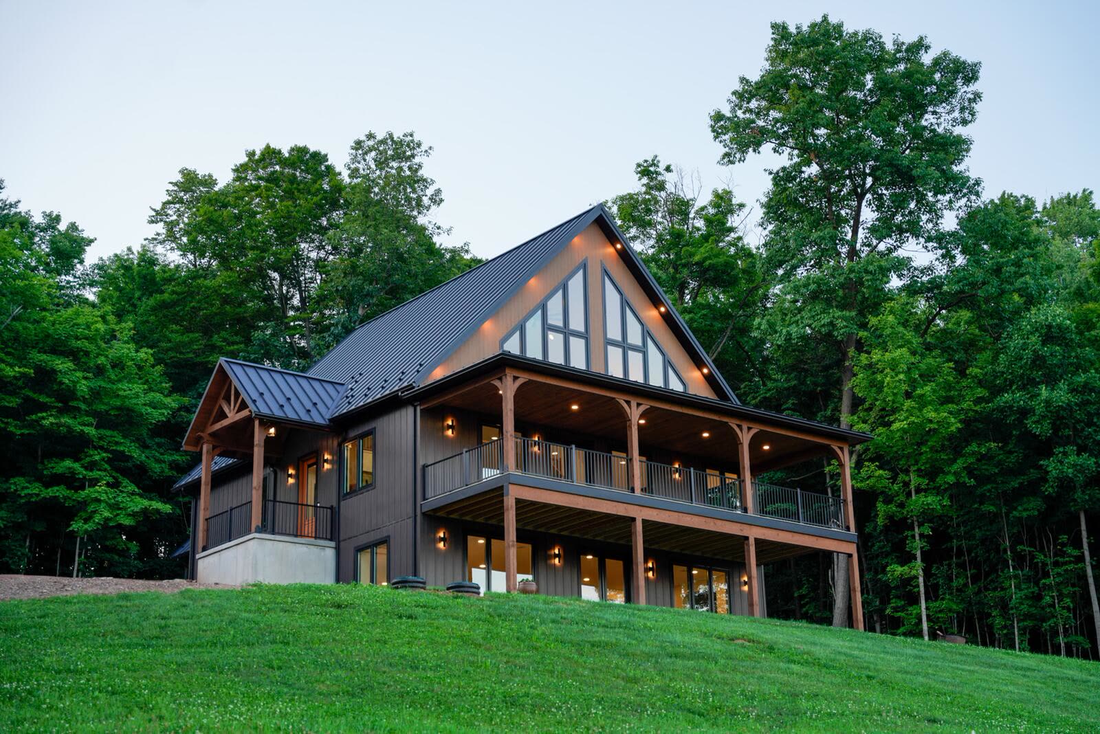 Custom new home at dusk with wraparound porches built by KB Builders in Central Pennsylvania