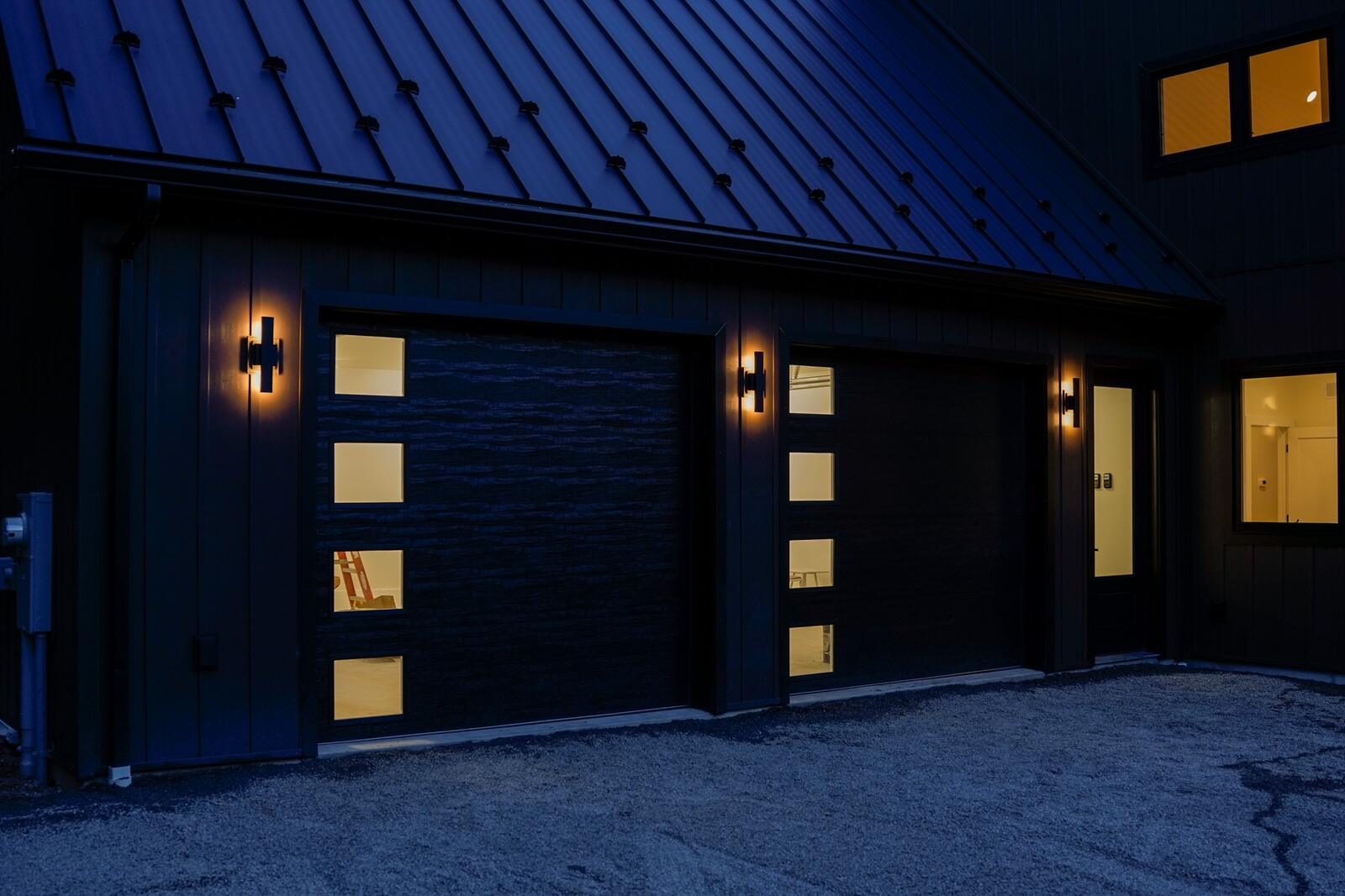 Detached garage with black metal roof, board-and-batten siding, and glass-panel doors built by KB Builders, Central Pennsylvania