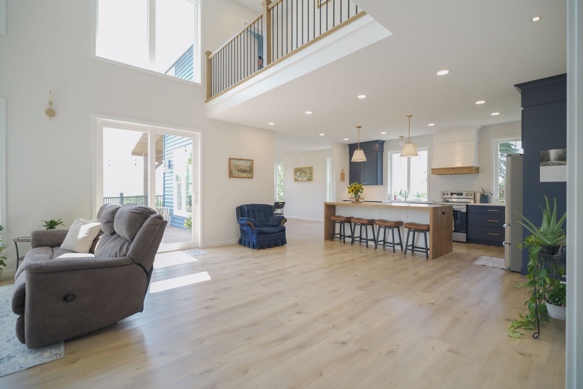 Byler Residence — open-concept great room flowing into the kitchen beneath the upstairs loft — KB Builders, Central Pennsylvania