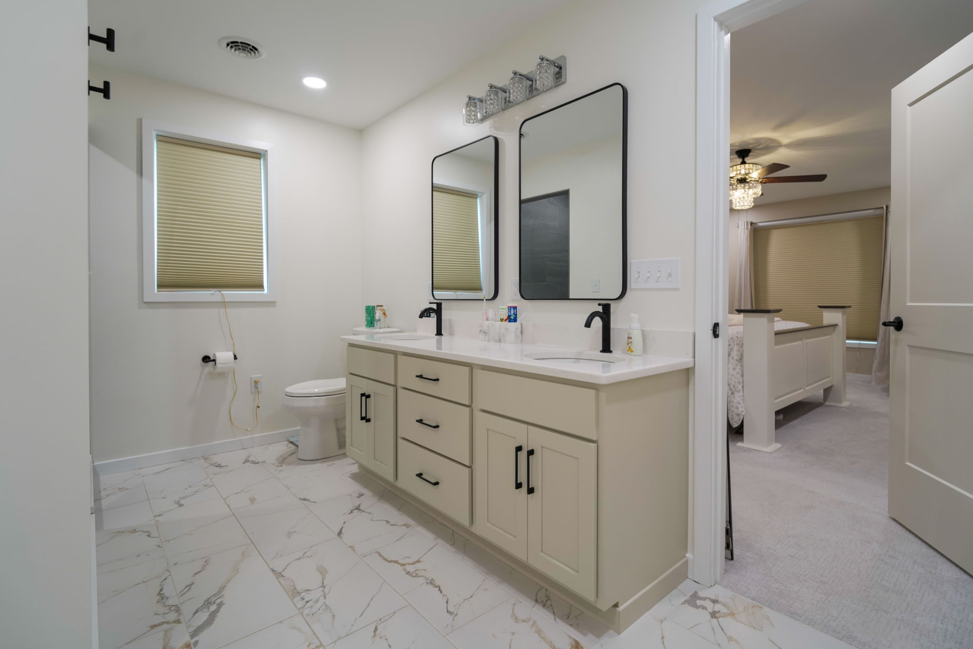 Yoder Residence — primary bath with double vanity, marble-look tile floor, and matte black fixtures — KB Builders, Central Pennsylvania