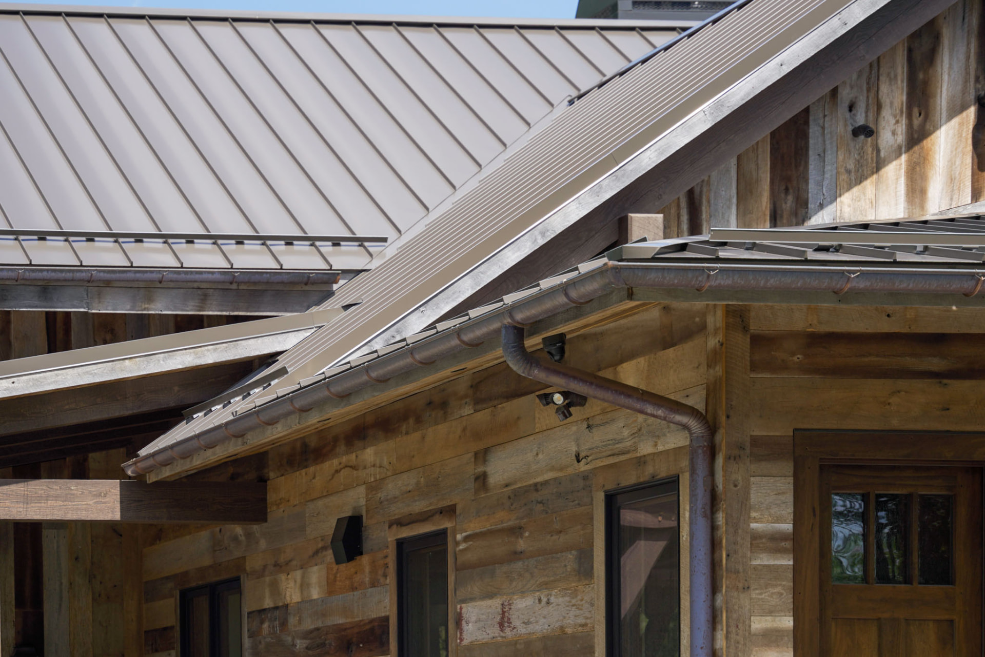 Wright Residence — standing-seam metal rooflines with half-round gutters over reclaimed wood siding — KB Builders, Central Pennsylvania