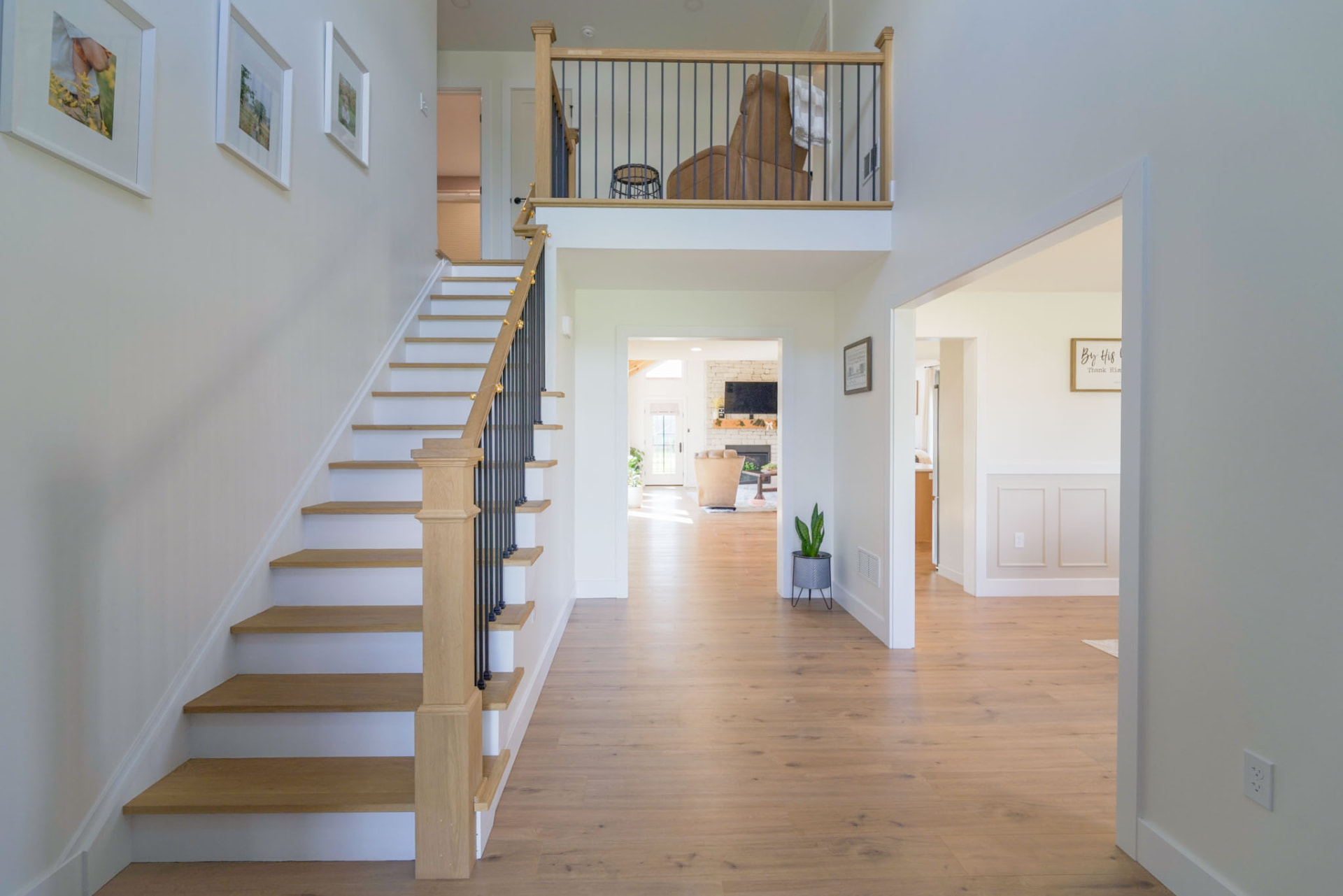 Yoder Residence — two-story foyer with white oak stair treads, iron balusters, and open sightlines to the great room — KB Builders, Central Pennsylvania