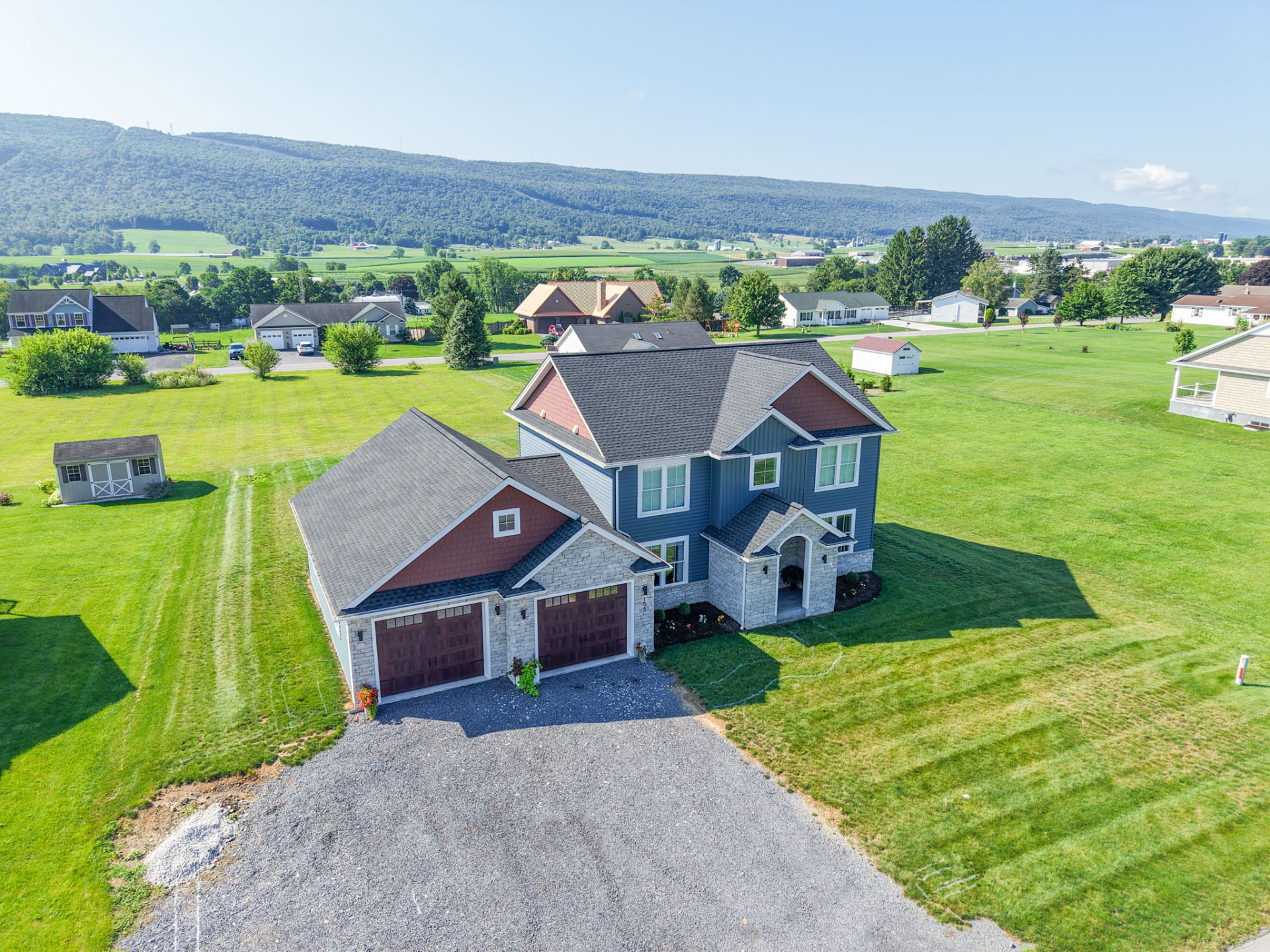 Aerial view of a completed KB Builders custom home and site set against Central Pennsylvania farmland