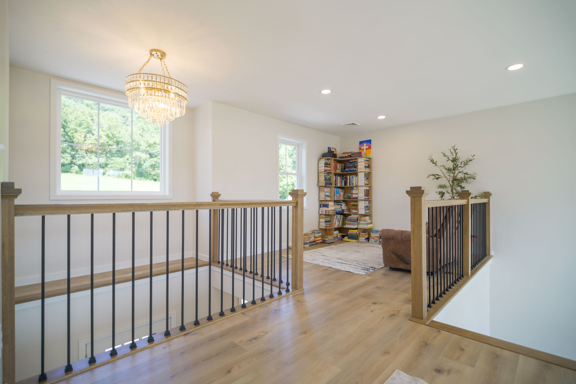 Byler Residence — upstairs loft library with oak railings and crystal chandelier — KB Builders, Central Pennsylvania